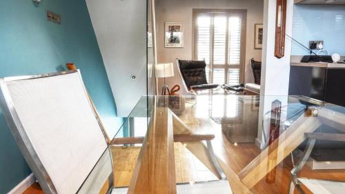 a glass table in a room with a living room at Modern Seaside Townhouse feat Sauna near Brighton in Shoreham-by-Sea