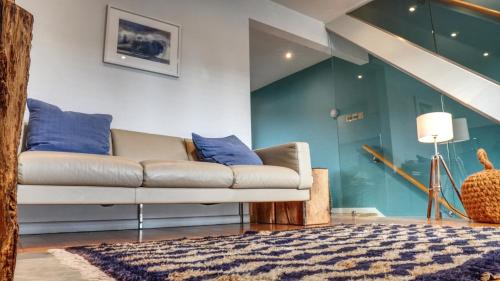 a living room with a couch and a rug at Modern Seaside Townhouse feat Sauna near Brighton in Shoreham-by-Sea