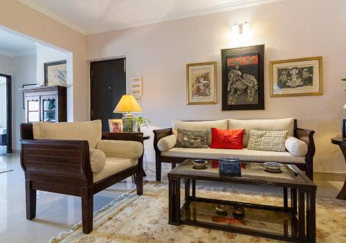 a living room with a couch and a table at Neelam Bed & Breakfast in Kolkata