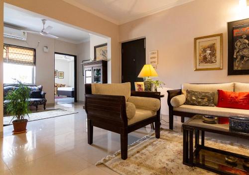 a living room with two couches and a table at Neelam Bed & Breakfast in Kolkata