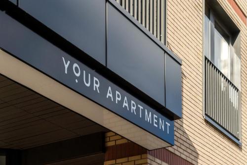 a sign that reads your apartmenturt on the side of a building at Your Apartment I Milton Keynes in Milton Keynes