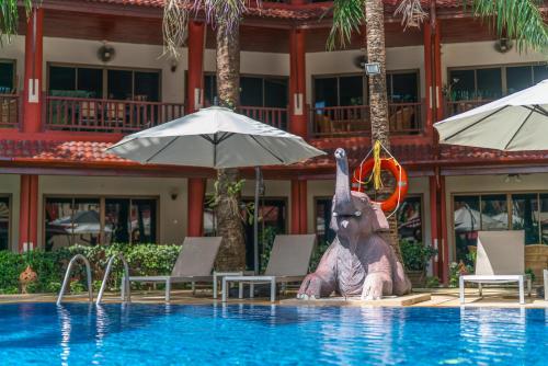 a statue of an elephant sitting in a swimming pool at Sai Rougn apartment in Patong Beach