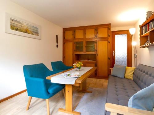 a living room with a couch and a table and chairs at Ferienbungalow Schultz in Altenkirchen in Altenkirchen