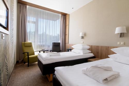 Postel nebo postele na pokoji v ubytování SPA VILNIUS Druskininkai