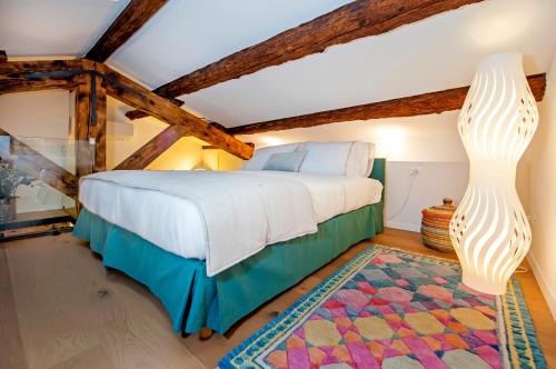 a bedroom with a bed and a ceiling with beams at Apartments Casa De Amicis in Rovinj