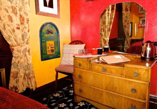 a room with a wooden dresser and a mirror at Fifteens of Chester in Chester