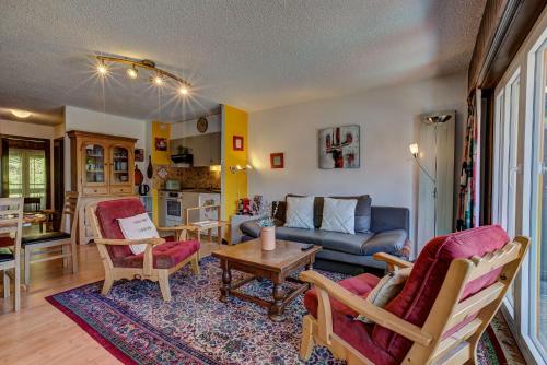 a living room with a couch and a table at Appartement Savoleyres 30 in La Tzoumaz