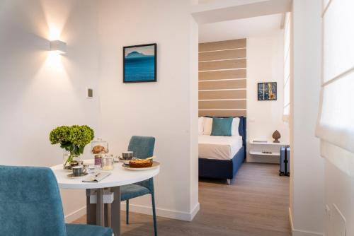 - un salon avec une table et un lit dans l'établissement La Musa Apartments & Rooms, à Palerme