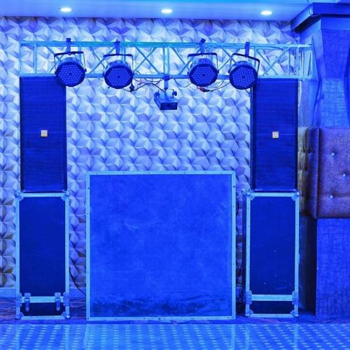 a room with blue doors and a stone wall at Hotel APJ GRAND in Faridabad