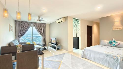 a bedroom with a bed and a living room at JB City Shopping Mall Apartment in Johor Bahru