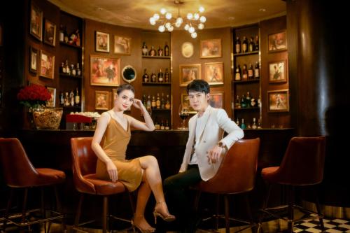 a man and a woman sitting in a bar at La Seine Hotel in Vientiane