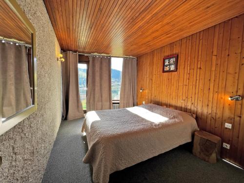 a bedroom with a bed in a room with a window at Aravis 1500-11 - 2 pieces et coin nuit in La Clusaz