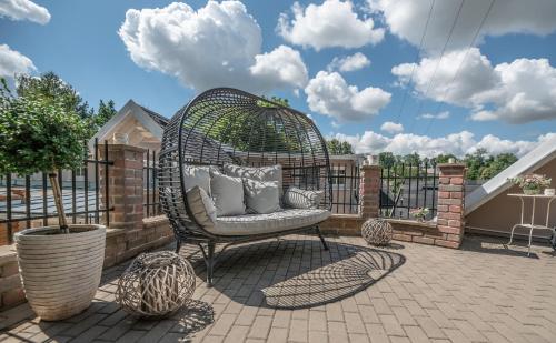 a wicker chair sitting on a patio at Penzion U Zběhlíka in Svitavy