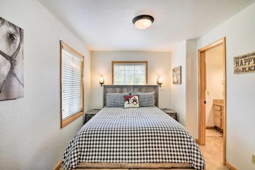 a bedroom with a bed with a black and white checkered blanket at Cozy Cabin with Mountain Views about 4 Mi to Grand Lake! in Grand Lake