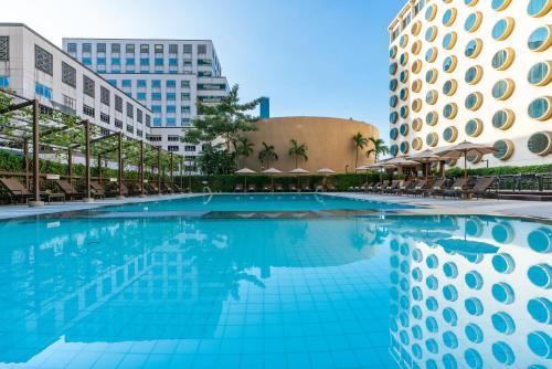 a swimming pool in front of a building at Holiday Inn Bangkok Silom, an IHG Hotel in Bangkok