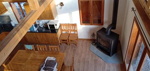 an overhead view of a living room and kitchen with a stove at Maison cœur tarentaise in Les Chapelles