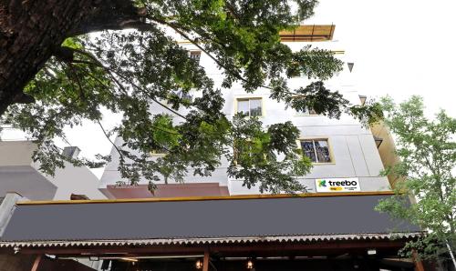 a white building with a sign on it at Itsy By Treebo - HSR Comfort in Bangalore