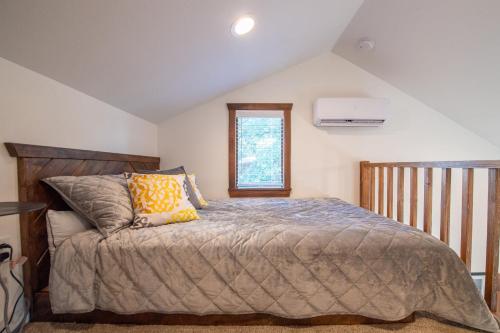 a bedroom with a large bed and a window at The Goldfinch Cabin 15 MIN to Magnolia Baylor in Elm Mott