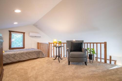 a bedroom with a bed and a chair at The Goldfinch Cabin 15 MIN to Magnolia Baylor in Elm Mott