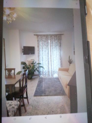 a living room with a couch and a table at Casa Silvio in Torri del Benaco