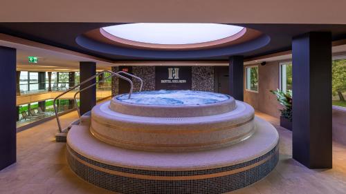 a large tub in the middle of a building at Hotel Helikon, Keszthely in Keszthely