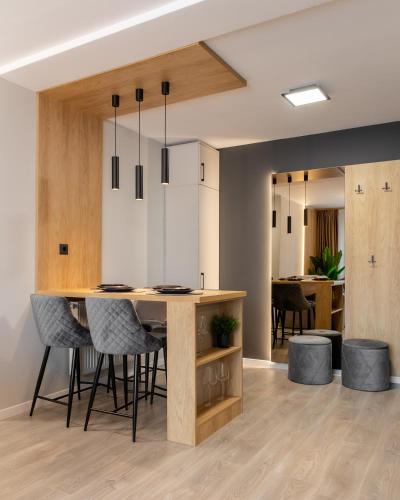 a kitchen and dining room with a table and chairs at FLH - The Nest in Şelimbăr