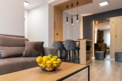 a bowl of fruit on a table in a living room at FLH - The Nest in Şelimbăr