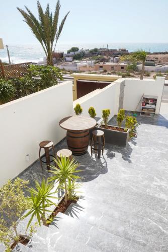 a patio with a table and chairs on a roof at Isli by Mood 4 ou 5 Px Luxe in Imsouane