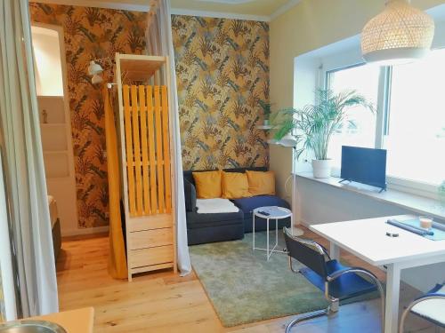 a living room with a couch and a table at City Apartment am Lendkanal, Klagenfurt in Klagenfurt