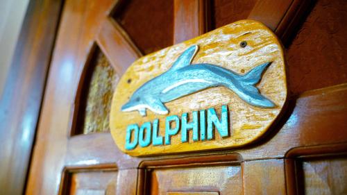 a sign on a door with a dolphin on it at DiveGurus Boracay Beach Resort in Boracay