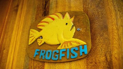 a wooden sign with a fish on it at DiveGurus Boracay Beach Resort in Boracay