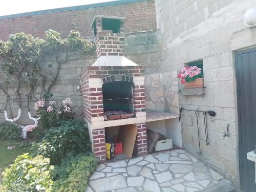 a brick oven in the side of a building at Charmant studio centre bourg in Woincourt