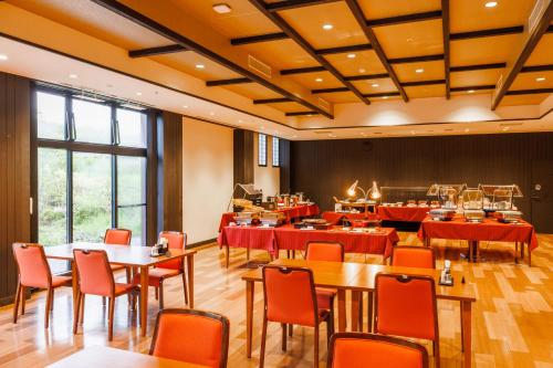 KAMENOI HOTEL Nara في نارا: مطعم فيه طاولات وكراسي في الغرفة