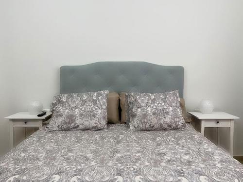a bedroom with a bed with two night stands at Comfortable family house with pool and jacuzzi in Costa de Antigua