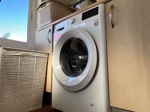 a washing machine in a room with a window at Comfortable family house with pool and jacuzzi in Costa de Antigua