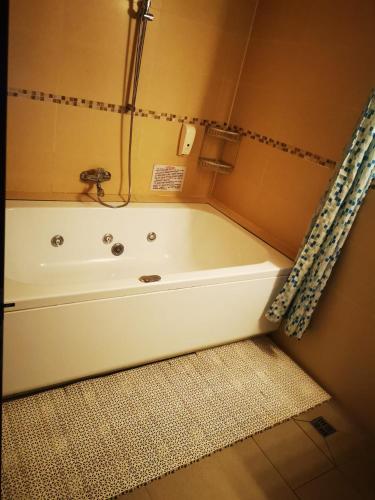 a bath tub in a bathroom with a shower at Hotel Viva in Ploieşti