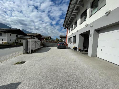 a car parked next to a white building at Appartement Sammer in Piesendorf