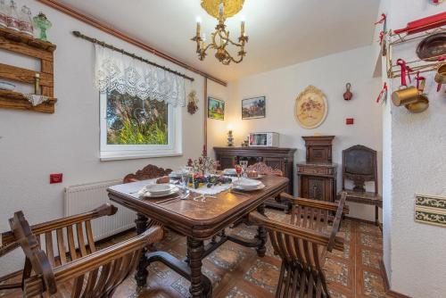 a dining room with a table and two chairs at Magnus Lupus in Korenica