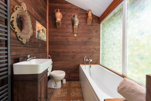 a bathroom with a tub and a toilet and a sink at Magnus Lupus in Korenica