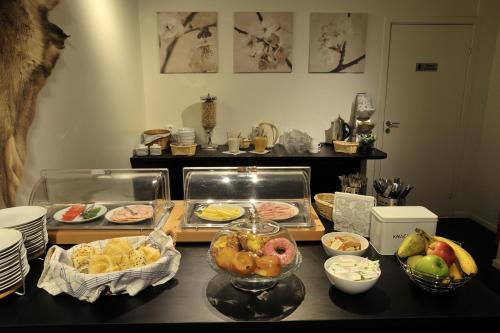 a table with many different types of food on it at Hedenstugan B&B Hotel in Bergby