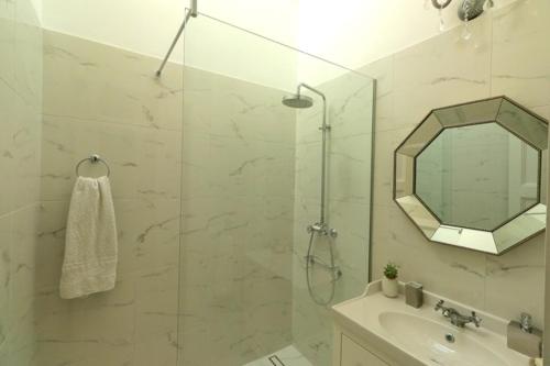 a bathroom with a shower and a sink and a mirror at Apartment MiraMare on the beach in Split