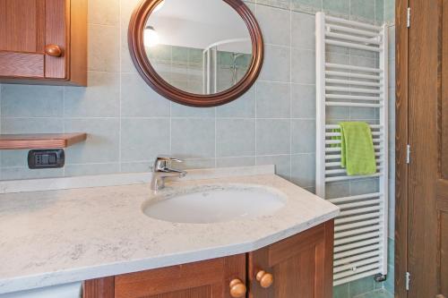 a bathroom with a sink and a mirror at Appartamento Silvia in Valdisotto