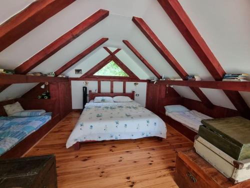 a bedroom with two beds in a attic at Grab cabin in Pluzine