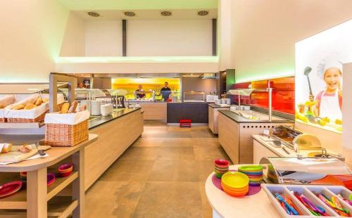 a large kitchen with a bunch of food at All in Red Thermenhotel in Lutzmannsburg