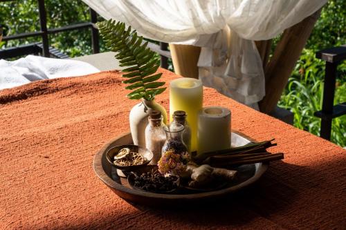a tray with candles and other items on a table at Buahan, a Banyan Tree Escape in Payangan