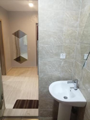 a bathroom with a sink and a shower at Amazing Grace Hostel and International Serviced Apartments in Ibadan