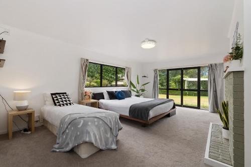 a bedroom with two beds and a fireplace at skyline mountain view Lodge up to 16 people in Rotorua