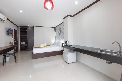 a hotel room with a bed and a sink at The Chic Patong in Patong Beach