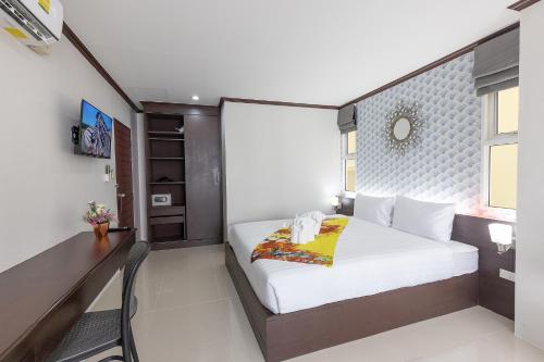a hotel room with a bed and a desk at The Chic Patong in Patong Beach