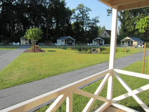 a view of a park from the porch of a house at Lodgepark 't Vechtdal in Dalfsen